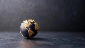 A globe with gold and black paint on it photo