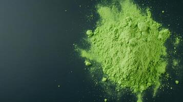 Vibrant green matcha powder scattered on dark surface, showcasing its fine texture and color photo