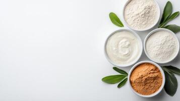Various types of powder in bowls on a white background photo