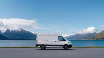 parked van by serene lakeside with mountains in background creates peaceful scene photo