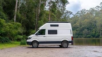 parked camper van by serene lakeside surrounded by lush greenery evokes sense of adventure photo