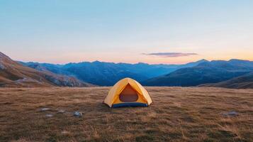 bright yellow tent stands alone vast alpine landscape, surrounded by majestic mountains twilight photo