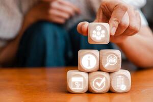 Visual representation of a management information system using digital icons and wooden blocks, symbolizing modern business solutions. photo