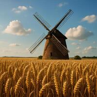 Windmill Standing Tall in Golden Wheat Fields Under Blue Skies photo