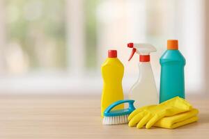 Cleaning Supplies Arranged on a Wooden Table for Home Cleaning Tasks photo