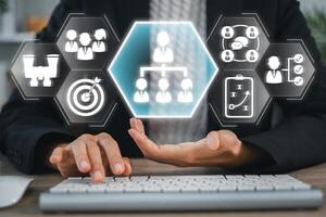 A business professional uses a digital interface to delegate tasks efficiently in a modern office environment. photo