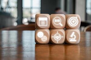 Creative representation of marketing using digital icons on wooden blocks, symbolizing modern advertising techniques. photo