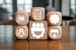 Wooden blocks with digital icons symbolize release management, showcasing software development and project planning concepts. photo