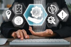 A business professional uses digital tools and icons to manage time effectively, symbolizing productivity and efficient workflow. photo