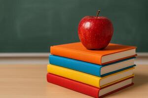 Stacked Books With a Red Apple on Top in Classroom Setting During Study Session photo
