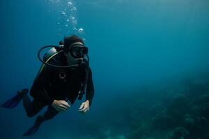 Diver Exploring Underwater Coral Reef During Daylight in Clear Blue Ocean photo