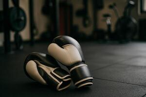 Boxing Gloves Resting on Gym Floor After Intense Workout Session at Local Fitness Center photo