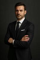 Professional Man in a Suit Posing Confidently Against a Dark Background photo