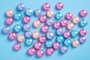 Colorful Decorative Pearls Arranged on a Blue Background for Creative Projects or Crafts photo