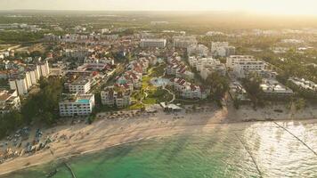 Aerial view of a tourist residence with a pool in the middle at sunset video