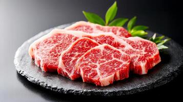 Raw beef steak on black stone plate photo