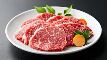 A plate of raw beef with a slice of lemon photo