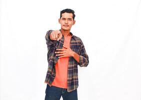 Expressive young man in casual clothing points directly towards the camera lens photo
