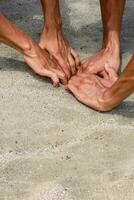 Intertwined Hands on Textured Surface Symbolizing Unity and Collaboration photo