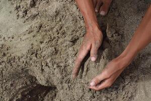 Hands Engaging with Sandy Terrain, Texture Exploration and tactile perception photo