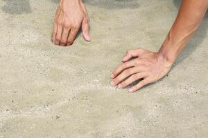 Hands Interacting with Sand, A Tactile Experience photo