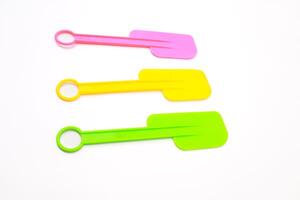 Colorful Silicone Spatulas Arrayed on a White Surface for Culinary Use photo