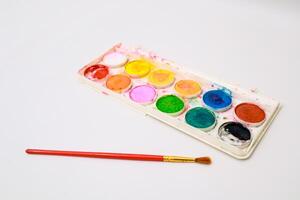 Palette of Colorful Watercolors and Brush Ready for Artistic Creation photo