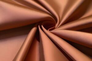 Peach Satin Fabric Swirl Texture Luxurious and Smooth photo