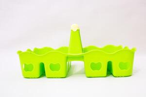 Vibrant Green Plastic Caddy Isolated on White for Versatile Usage and Style photo