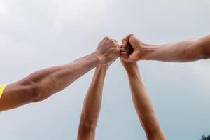 Diverse Team Fists Bump in the Sky Showcasing Unity and Teamwork Spirit photo
