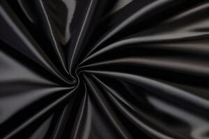 Elegant Black Fabric Texture Swirling folds of luxurious dark textile, showcasing a dramatic and sophisticated aesthetic. Ideal for fashion, design, and branding projects. photo