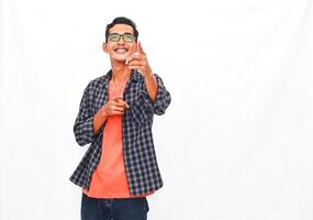 Smiling Young Person in Casual Outfit Pointing and Gesturing Against Plain Background photo