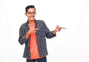 Smiling Young Man Pointing Gesturing In A Casual Shirt, White Background photo