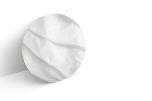 A white circular object on a white surface photo
