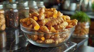 A bowl filled with raw tumeric on a counter photo