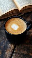 Coffee with a heart on a book on a wooden table photo