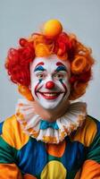 A clown wearing a colorful wig and red hair photo