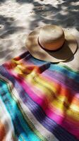 A hat and a blanket on the beach photo