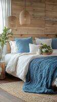 A bedroom with wooden walls and a blue bed photo