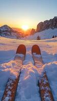 Skis on the snow at sunset photo