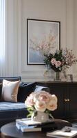 A living room with a blue sofa, a coffee table and a painting photo