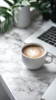 Coffee and laptop on a desk photo