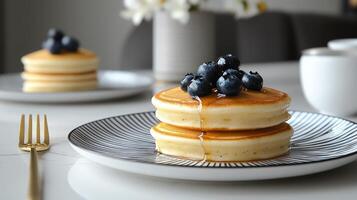 A stack of pancakes with blueberries on top photo