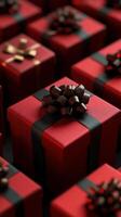 Many red gift boxes with black bows photo