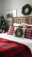 A christmas bedroom with red and black plaid bedding photo
