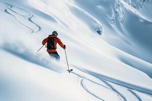 A person skiing down a snow covered slope photo