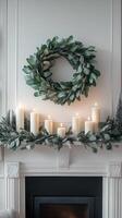 A wreath of eucalyptus leaves and candles on a fireplace photo