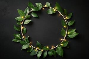 A wreath of green leaves and lights on a black background photo