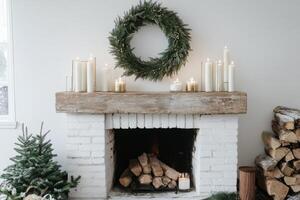 A white fireplace with a wreath and candles photo