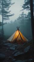 A tent in the woods on a foggy day photo